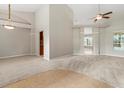 Spacious living room featuring high ceilings and carpet flooring with a view of the pool at 802 Se 50Th Ter, Ocala, FL 34471