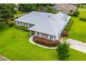 Charming home with a well-maintained roof, landscaped yard, and brick accents, with a long driveway at 828 Ne 51St Ave, Ocala, FL 34470
