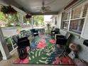 Cozy covered front porch featuring a vibrant tropical rug, comfortable seating, and hanging floral arrangements at 8712 Sw 92Nd Pl # D, Ocala, FL 34481