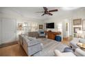 Bright living room featuring hardwood floors, shuttered windows, and comfortable seating arrangement at 8712 Sw 92Nd Pl # D, Ocala, FL 34481