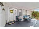 Inviting front porch features comfortable seating, creating a cozy and welcoming outdoor space at 9015 Sw 94Th St # D, Ocala, FL 34481