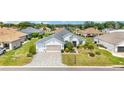 Attractive single-story home featuring mature landscaping and brick-paved driveway at 9290 Se 120Th Loop, Summerfield, FL 34491
