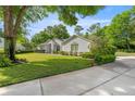 Well-maintained one-story home with green lawn, mature trees, and tasteful landscaping at 9579 Sw 195 Cir, Dunnellon, FL 34432