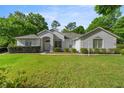 Attractive one-story home with green grass, healthy bushes, and inviting curb appeal at 9579 Sw 195 Cir, Dunnellon, FL 34432