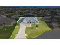 An aerial view of the property showing the home, lawn, and surrounding neighborhood at 9957 Sw 55Th Avenue Rd, Ocala, FL 34476