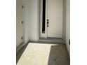 Modern front door with sidelight and sleek hardware, offering a stylish entrance to the home at 11537 Sw 59Th Ter, Ocala, FL 34476