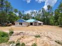 New construction home featuring block construction, a covered entry, and large lot at 13131 Sw 52Nd Lane Rd, Ocala, FL 34481