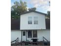 Modest two-story home with wood siding and a grill on the back deck at 14953 Se 107Th Ave, Summerfield, FL 34491