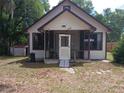 Charming single-story home with a cozy front porch and mature trees in a quiet neighborhood at 14953 Se 107Th Ave, Summerfield, FL 34491