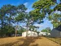 Fenced backyard with several large mature trees adding shade to the residence at 32 Spring Loop Circle, Ocala, FL 34472