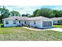 Inviting single-story home with a well-kept lawn and a screened garage for added curb appeal at 4998 Nw 30Th Pl, Ocala, FL 34482