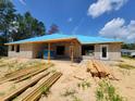 Block home construction in the backyard featuring a covered patio and wood at 9553 Sw 42Nd Ave, Ocala, FL 34476