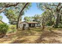 A serene single-story house nestled among mature trees, offering privacy and a peaceful setting at 10060 Se 106Th Ln, Belleview, FL 34420
