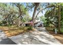 Lovely single-story home with a long driveway, surrounded by beautiful mature trees and a welcoming front yard at 10060 Se 106Th Ln, Belleview, FL 34420
