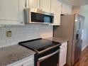 A close view of the kitchen with stainless steel appliances and granite countertops at 11250 Sw 76Th Ave, Ocala, FL 34476