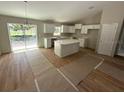 Bright kitchen featuring white cabinets, a center island, stainless steel appliances, and abundant natural light at 13714 Sw 114Th Pl, Dunnellon, FL 34432