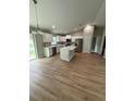 Bright open-concept kitchen with stainless steel appliances and a large island at 13714 Sw 114Th Pl, Dunnellon, FL 34432