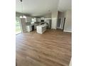 Bright open-concept kitchen with stainless steel appliances and a large island at 13714 Sw 114Th Pl, Dunnellon, FL 34432