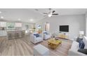 Open-concept living area with stylish furnishings, a ceiling fan, and a view of the dining area and kitchen at 13714 Sw 114Th Pl, Dunnellon, FL 34432