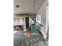 Covered porch area featuring a ramp for accessibility and a seating area at 2323 Sw 3Rd St, Ocala, FL 34471