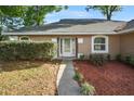Inviting front door with decorative glass and manicured landscaping at 4246 Ne 32Nd Cir, Ocala, FL 34479