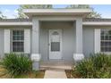 Inviting front entrance with a covered porch and well-maintained landscaping at 44 Pecan Run Dr, Ocala, FL 34472
