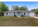 Charming single-story home with a well-manicured lawn and attached garage at 44 Pecan Run Dr, Ocala, FL 34472