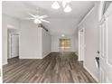 Bright living room featuring vaulted ceilings, a ceiling fan, and wood-look floors at 44 Pecan Run Dr, Ocala, FL 34472