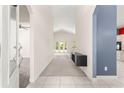Bright foyer with neutral walls, high ceilings, tile flooring, and entryway to other rooms at 4780 Sw 103Rd Street Rd, Ocala, FL 34476