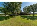Beautiful home with a sprawling front lawn, mature trees, and well-maintained landscaping at 5363 Nw 153Rd Ct, Morriston, FL 32668