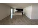 Spacious open concept with tile floors, large island, stainless appliances and dark cabinets at 593 Marion Oaks Trl, Ocala, FL 34473