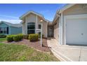 Welcoming front entrance with well manicured landscaping and a decorative driveway at 710 Antonia Ln, The Villages, FL 32159