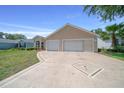 Beautifully landscaped single-story home with a spacious two-car garage and decorative driveway at 710 Antonia Ln, The Villages, FL 32159
