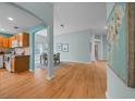 Spacious open-concept room with hard wood flooring, an arched doorway, and decorative artwork at 710 Antonia Ln, The Villages, FL 32159