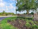 Community entrance sign 'SummerHill' surrounded by lush landscaping and a glimpse of the neighborhood gate at 7161 Ne 22Nd Court Rd, Ocala, FL 34479