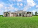 Stunning single-story home featuring lush green grass, a meticulously kept lawn and a symmetrical front facade at 7161 Ne 22Nd Court Rd, Ocala, FL 34479