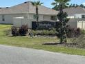 Community entrance sign for Huntington Ridge, surrounded by well-maintained landscaping and palm trees at 7198 Sw 136Th Street Rd, Ocala, FL 34473
