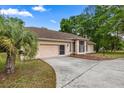 Single Gathering home with an attached two car garage and mature trees and landscaping at 8221 Sw 217 Ct, Dunnellon, FL 34431