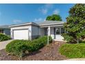 Single-story home with a two-car garage, gray exterior paint, and manicured landscaping at 8546 Sw 79Th Ave, Ocala, FL 34476