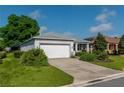 Well maintained single-story home featuring a manicured lawn, neutral exterior paint, and a two-car garage at 8546 Sw 79Th Ave, Ocala, FL 34476