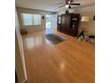 Bright living area featuring wood floors, ceiling fan, and exterior access at 8680 Sw 94Th St # D, Ocala, FL 34481