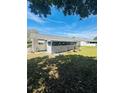 The backyard has a screened in porch that overlooks the landscaped yard at 8683 Sw 62Nd Ct, Ocala, FL 34476