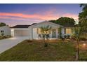 Charming single-story home with a well-manicured lawn at dusk at 8851 Sw 116Th Street Rd, Ocala, FL 34481