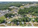 An aerial view of a home in a wooded neighborhood near a highway and commercial area at 8954 Sw 104Th Ln, Ocala, FL 34481