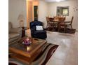 Open-concept living area with tile floors and a view of the adjacent dining space at 9121 Sw 83Rd Ct # C, Ocala, FL 34481