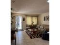 Cozy living room with tile flooring, comfortable seating, and natural light from the front entry at 9121 Sw 83Rd Ct # C, Ocala, FL 34481