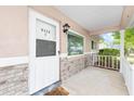 View of the home's covered front porch with brick accents, painted front door and address clearly displayed at 9320 Sw 89Th Ter # C, Ocala, FL 34481