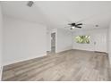 Bright living area with ceiling fan, neutral paint, wood-look floors, and doorway to other rooms at 9320 Sw 89Th Ter # C, Ocala, FL 34481