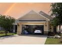 View of the garage with a white car parked inside, storage, and a neatly organized space at 9764 Sw 100Th Avenue Rd, Ocala, FL 34481