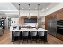 Modern kitchen features a large island, stainless steel appliances, and stylish pendant lighting at 0000 Se 17Th Ct, Ocala, FL 34471